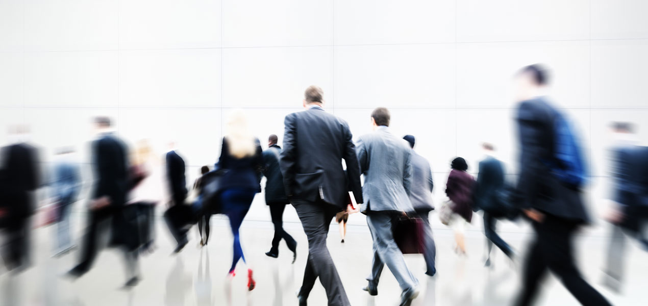 An out-of-focus view of crowd of business people walking.
