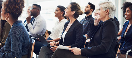 An audience of business people attending a conference.